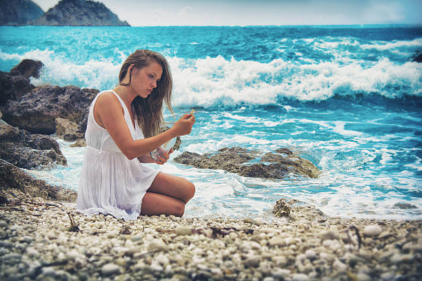 Beautiful young women sending a message with a bottle in the sea, Travels, Flight, Hotels