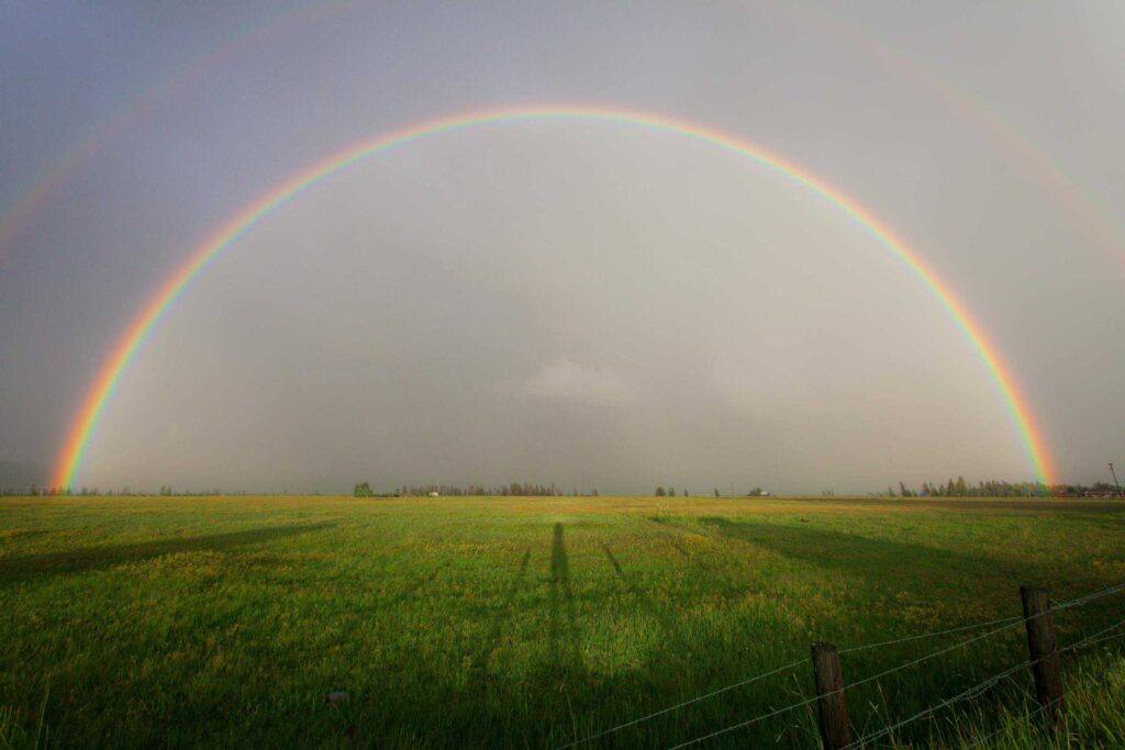 Rainbow on Grass Field. Thailand Weather.