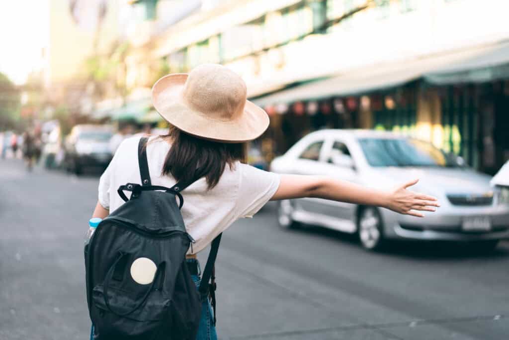 vecteezy back view of young asian traveller woman call a taxi for 7732456