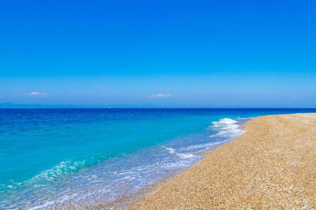 Elli beach coast landscape with turquoise clear water and view to Turkey on Rhodes Greece.