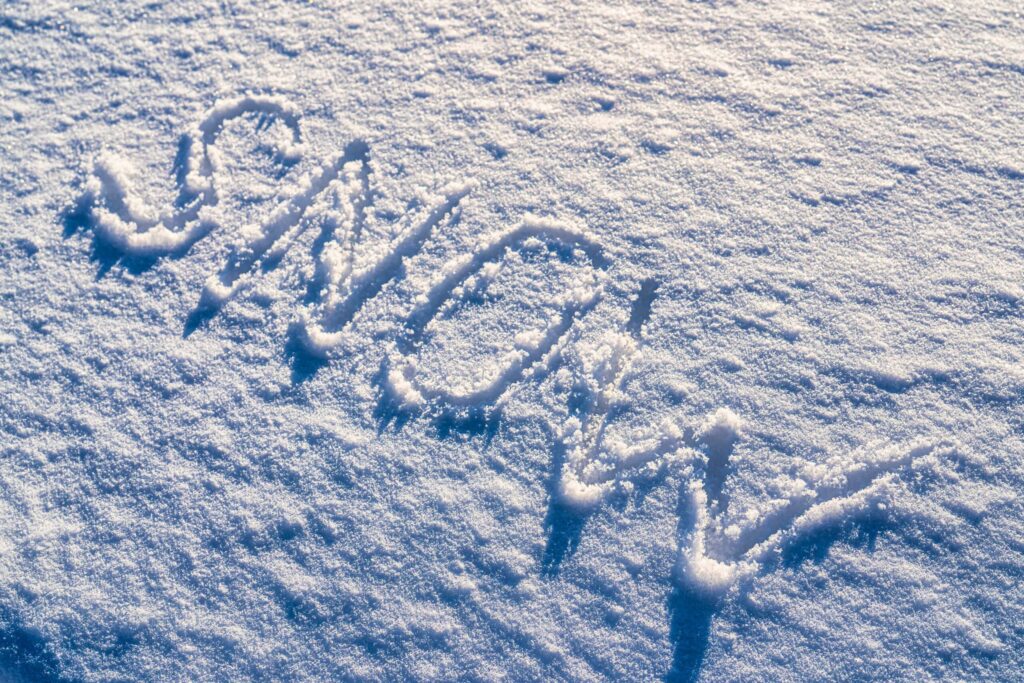 The word "snow" written on the snow in sunny weather. Winter and cold weather concept.Does It Snow in Australia?